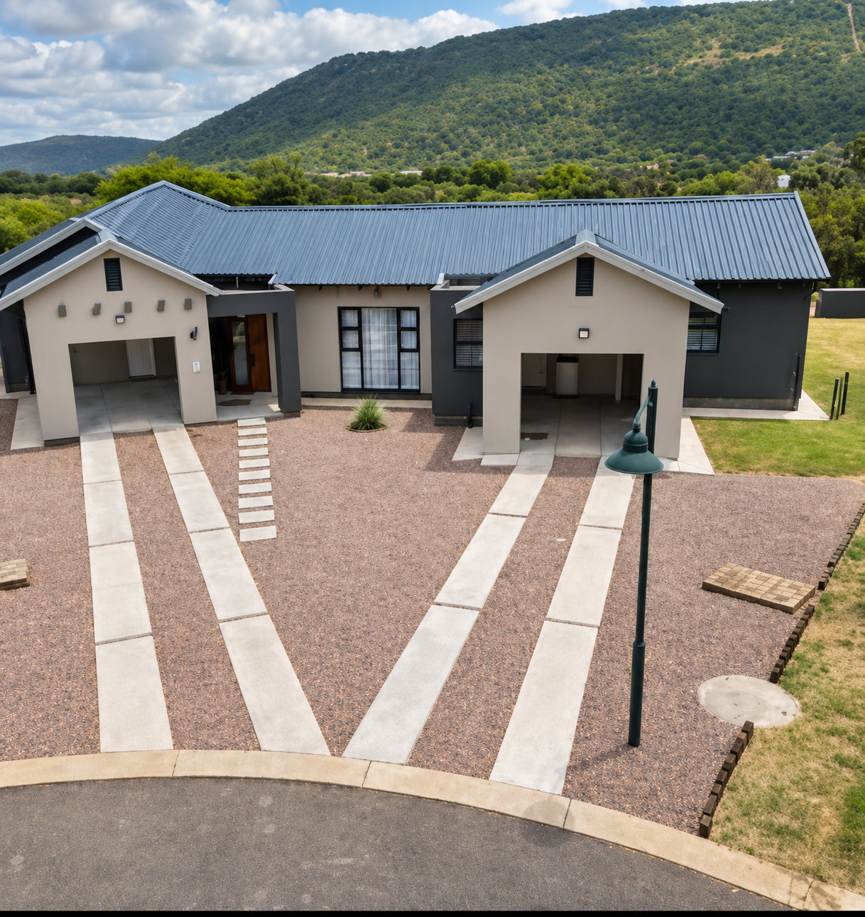 The arrival courtyard at Sango on 9 Euphoria with the Waterberg mountains rising behind the villa